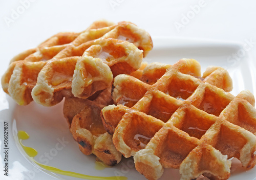 Two waffles with syrup on a plate