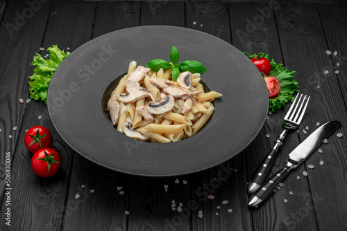 Penne pasta with mushrooms and chicken photo