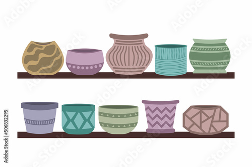 Ceramic empty multi-colored pots for home plants on the shelf