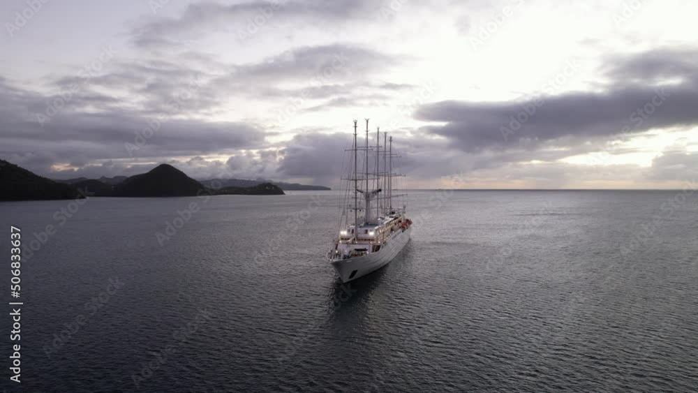 Big cruise ship anchored in Rodney Bay, Saint Lucia. Aerial view of boat on a cloudy evening. Luxury cabin cruiser at dusk, near Caribbean island. Big cruise ship anchored in Rodney Bay, Saint Lucia. Aerial view of boat on a cloudy evening. Luxury cabin cruiser at dusk, near Caribbean island.