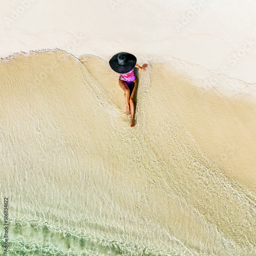 Beaches in the Maldives. Beautiful girl on the background of the sea and sandy beach. Travel and Tourism in the Maldives islands photo