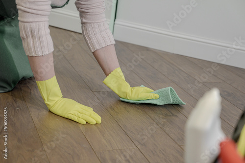 a woman washes the floor with a rag with detergents. house cleaning.