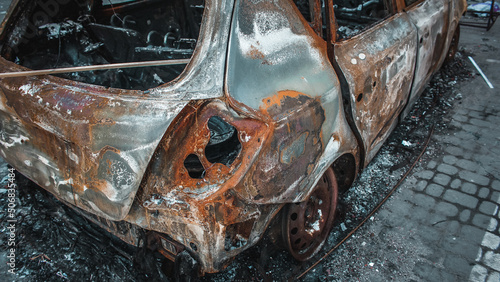 Obraz na płótnie Irpin, Kyiv Oblast, Ukraine - 19.05.2022: Cities of Ukraine after the Russian occupation. burnt civilian car in city of Irpin, northwest of Kyiv w salonie
