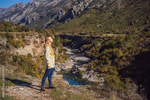 Montenegro. Woman tourist on the background of Clean clear turquoise water of river Moraca in green moraca canyon nature landscape. Travel around Montenegro concept