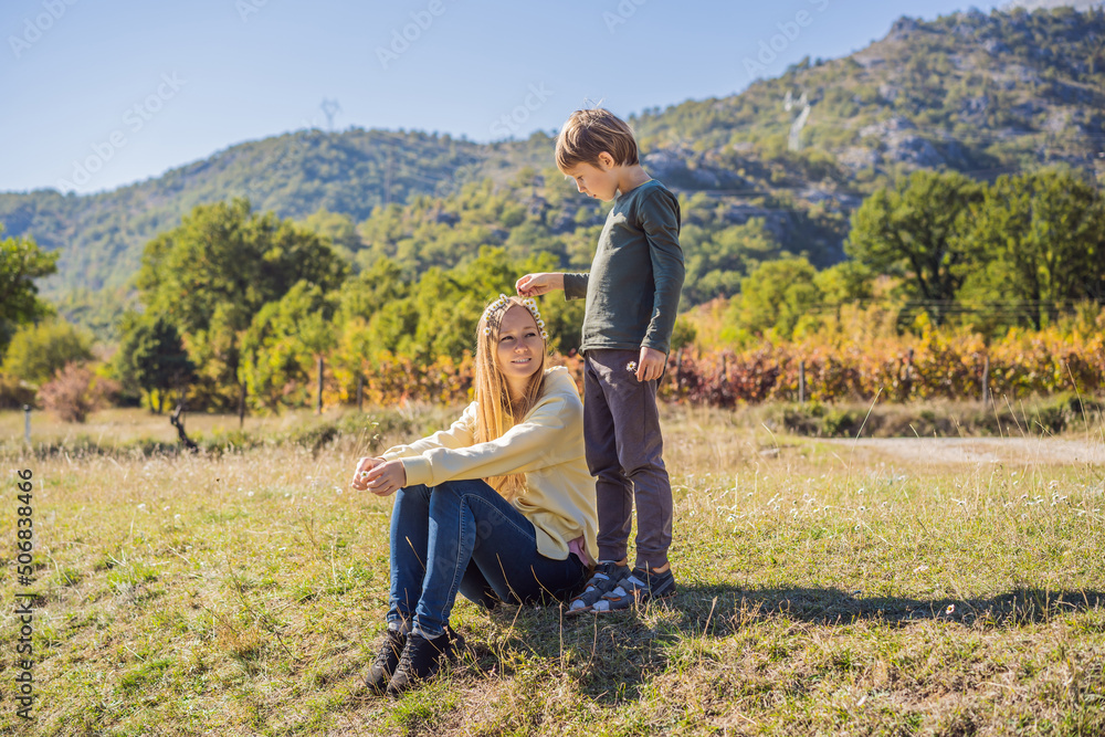 Montenegro. Mom and son tourists on the background of Clean clear turquoise water of river Moraca in green moraca canyon nature landscape. Travel around Montenegro concept Montenegro. Mom and son tourists on the background of Clean clear turquoise water of river Moraca in green moraca canyon nature landscape. Travel around Montenegro concept