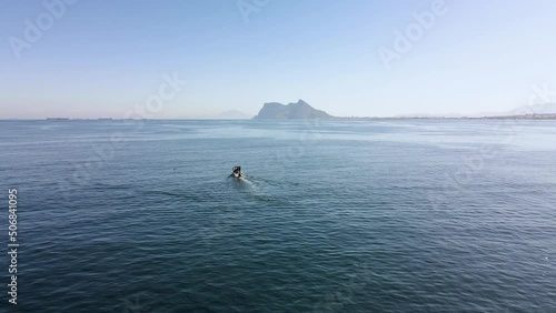 Navigating in the ocean with the rock of Gibraltar in the background. Aerial footage. British territory of Gibraltar, near Spain. 4K footage.