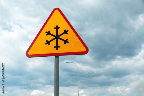 Road sign warning of road frosting, snowflake