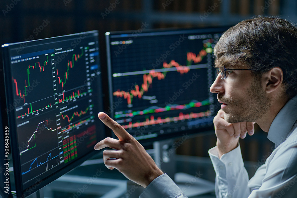 businessman comparing stock market data late in the evening .