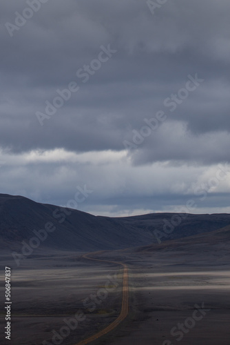 A solitary road through the rough Icelandic landscape.