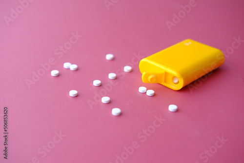 artificial sweetener container on red background 