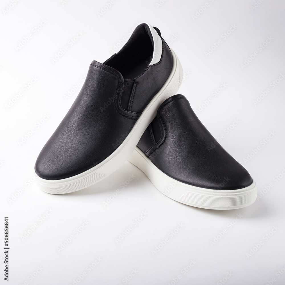 Pair of slip-on casual shoes on white background. Pair of slip-on casual shoes on white background.