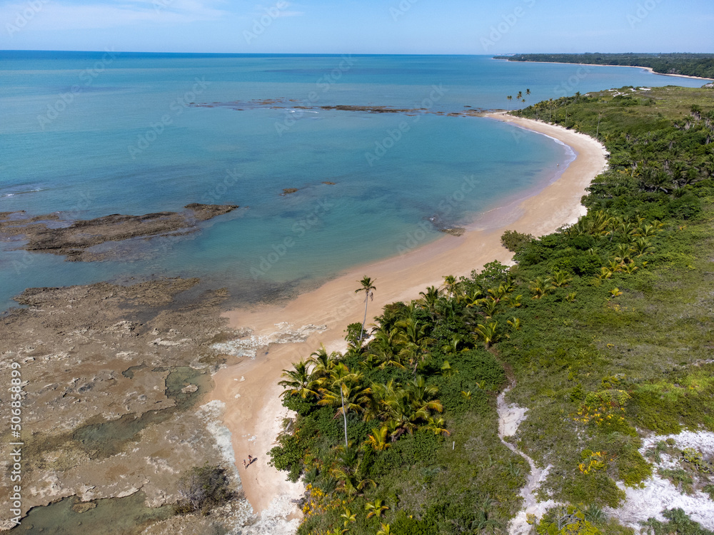 Amazing paradisiacal and deserted beach with clear blue waters and visible corals at low tide - Cumuruxatiba, Bahia, Brazil - aerial drone view