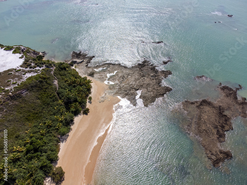 Amazing paradisiacal and deserted beach with clear blue waters and visible corals at low tide - Cumuruxatiba, Bahia, Brazil - aerial drone view