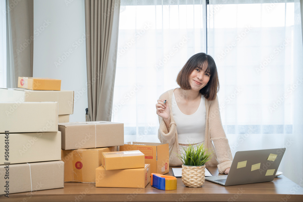 Asian woman packing in boxes to work at home Small Business Owners or Startup Small Business Entrepreneurs working on online marketing shipping boxes. Asian woman packing in boxes to work at home Small Business Owners or Startup Small Business Entrepreneurs working on online marketing shipping boxes.