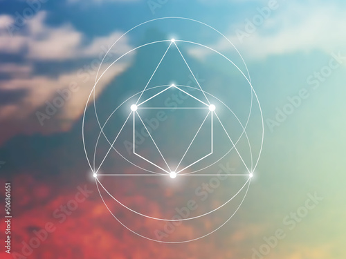 Sacred geometry spiritual new age futuristic illustration with interlocking circles, triangles and glowing particles in front of blurry natural photographic background