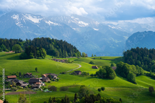 Obraz na płótnie amazing view on green hills and Alps in village near Thun in Switzerland w salonie