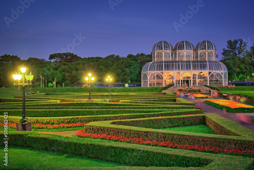Photograph of the Botanical Garden in Curitiba. Picture taken on a beautiful night with several tourists visiting one of the sights of the city.