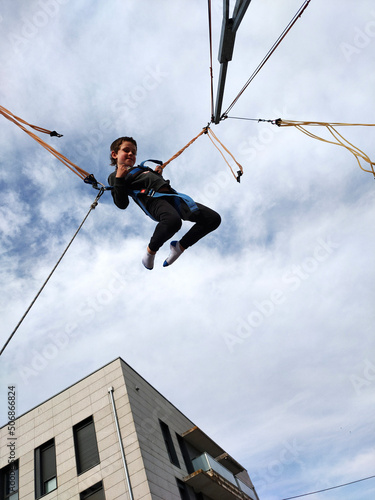 boy jumping on a zip line