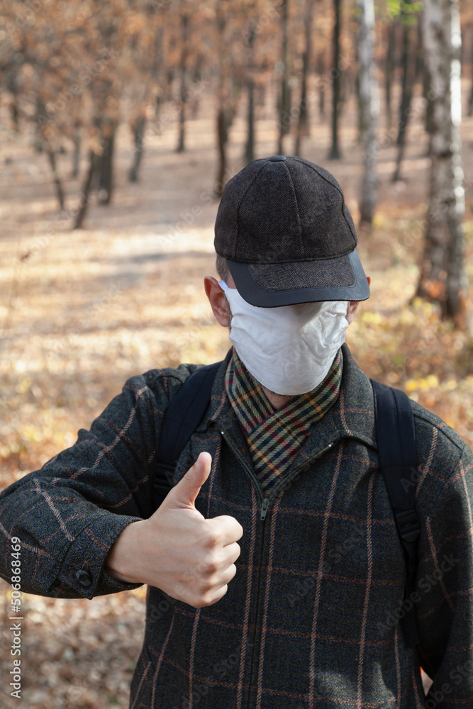 Man in cap and protective mask in nature Man in cap and protective mask in nature