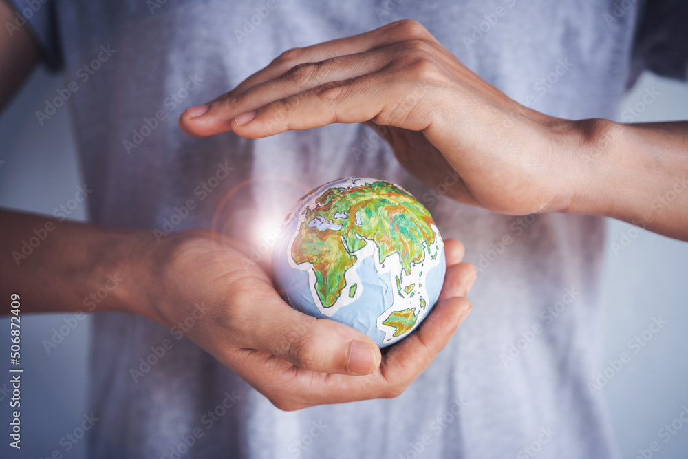 Woman holding earth in hands, Energy saving concept.