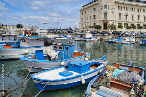 Obraz na płótnie Sicily, Italy - April 13, 2022: Sea coast with moored boats and fishing boats. Fishing village. w salonie