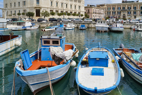 Obraz na płótnie Sicily, Italy - April 13, 2022: Sea coast with moored boats and fishing boats. Fishing village. w salonie