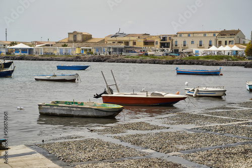 Obraz na płótnie Sicily, Italy - April 16, 2022: Sea coast with moored boats and fishing boats. Fishing village. w salonie