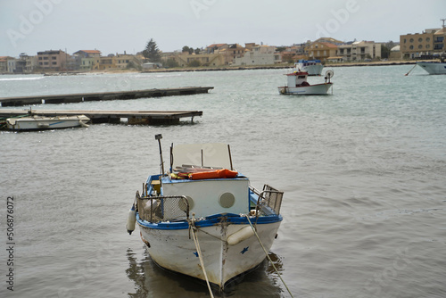 Obraz na płótnie Sicily, Italy - April 16, 2022: Sea coast with moored boats and fishing boats. Fishing village. w salonie
