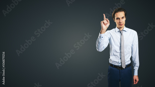 Fotografie Young handsome man in shirt with raising up hand and forefinger isolated on abst