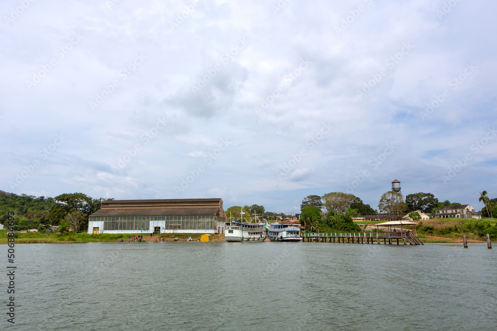 Fototapeta premium Beautiful view of Fordlandia city skyline in Amazon rainforest, Brazil. Tapajos river and historic water tank tower. Town built by Henry Ford in 1928 to produce rubber in the middle of the forest.
