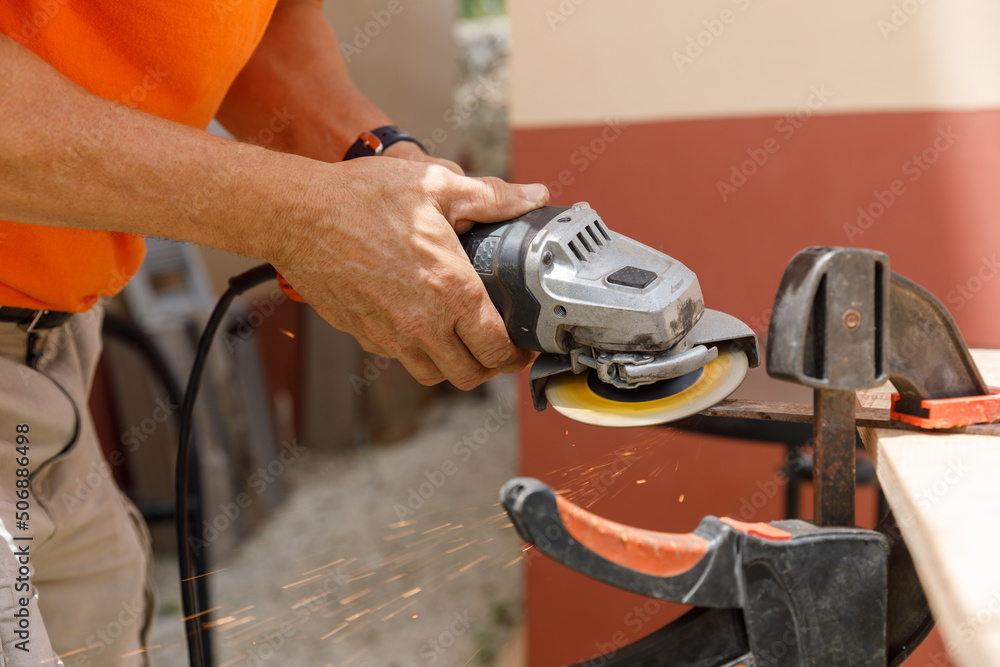 A man in his yard is engaged in locksmith work. Hobby, in a home workshop. A man in his yard is engaged in locksmith work. Hobby, in a home workshop.