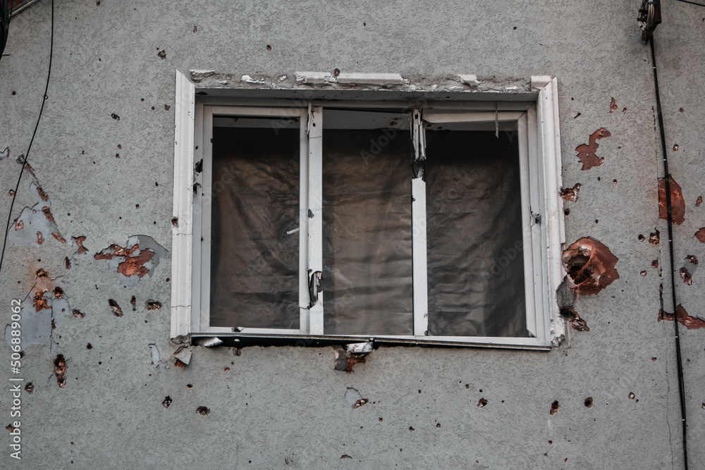 Irpin, Kyiv Oblast, Ukraine - 23.05.2022: Cities of Ukraine after the Russian occupation. destroyed civilian building in city of Irpin, northwest of Kyiv. Window close up