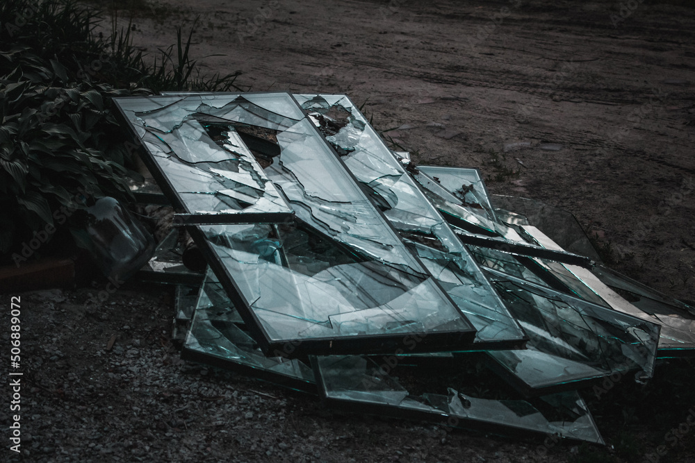 Irpin, Kyiv Oblast, Ukraine - 23.05.2022: Cities of Ukraine after the Russian occupation. broken glass in destroyed civilian windows in city of Irpin, northwest of Kyiv. Close up