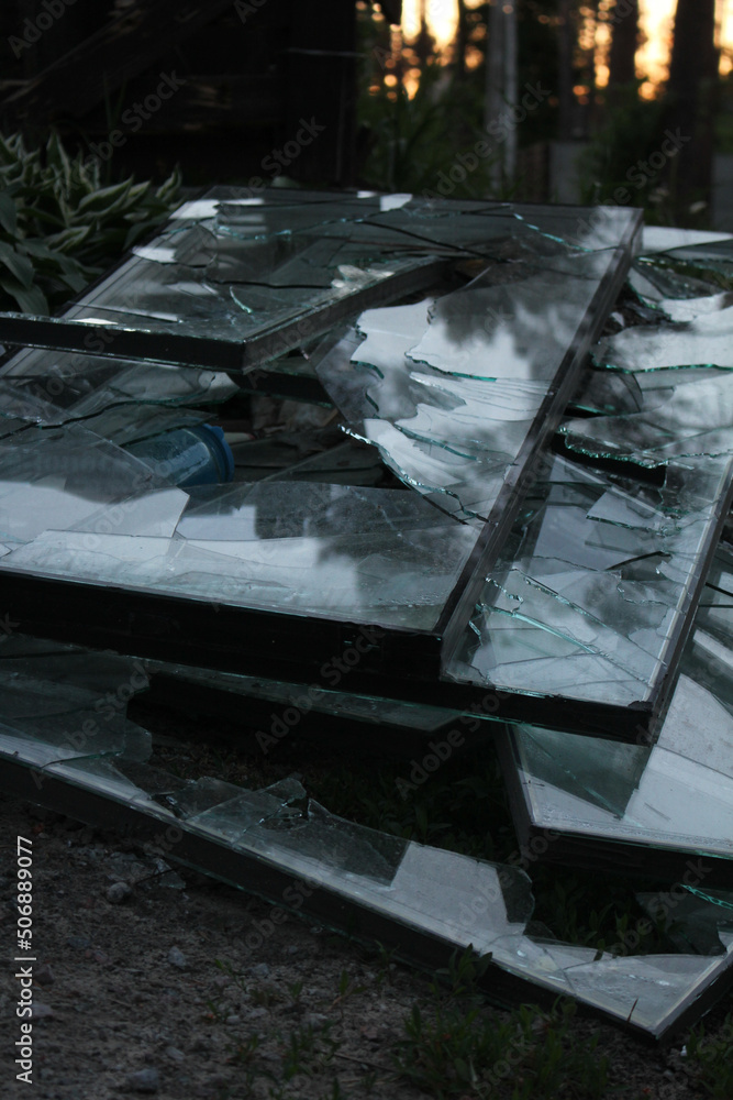 Irpin, Kyiv Oblast, Ukraine - 23.05.2022: Cities of Ukraine after the Russian occupation. broken glass in destroyed civilian windows in city of Irpin, northwest of Kyiv. Close up
