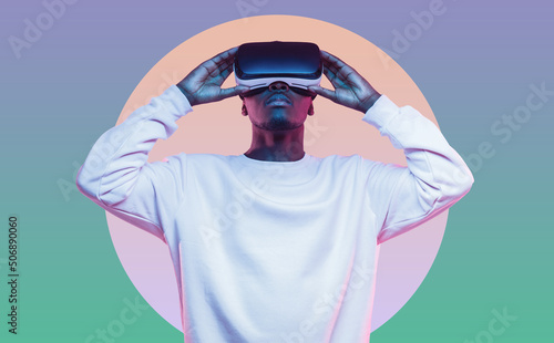 Young african man wearing virtual reality headset photo