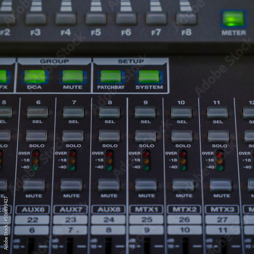 Control buttons and LED indicators on the mixing console. Selective focus