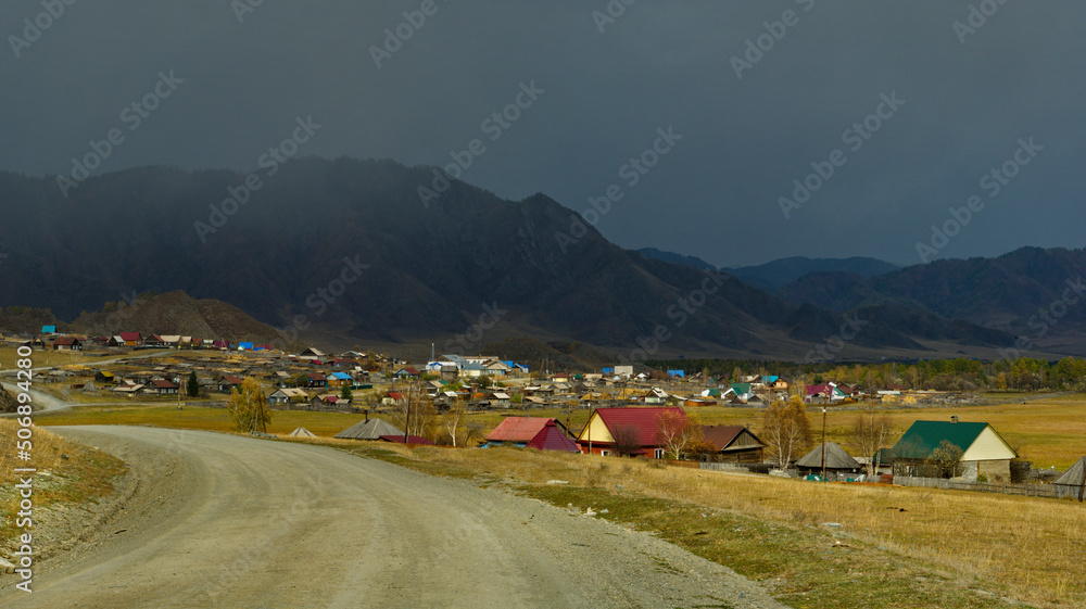 Russia. The South of Western Siberia, the Altai Mountains. Unpredictable weather over the village in the valley of the Karakol River.