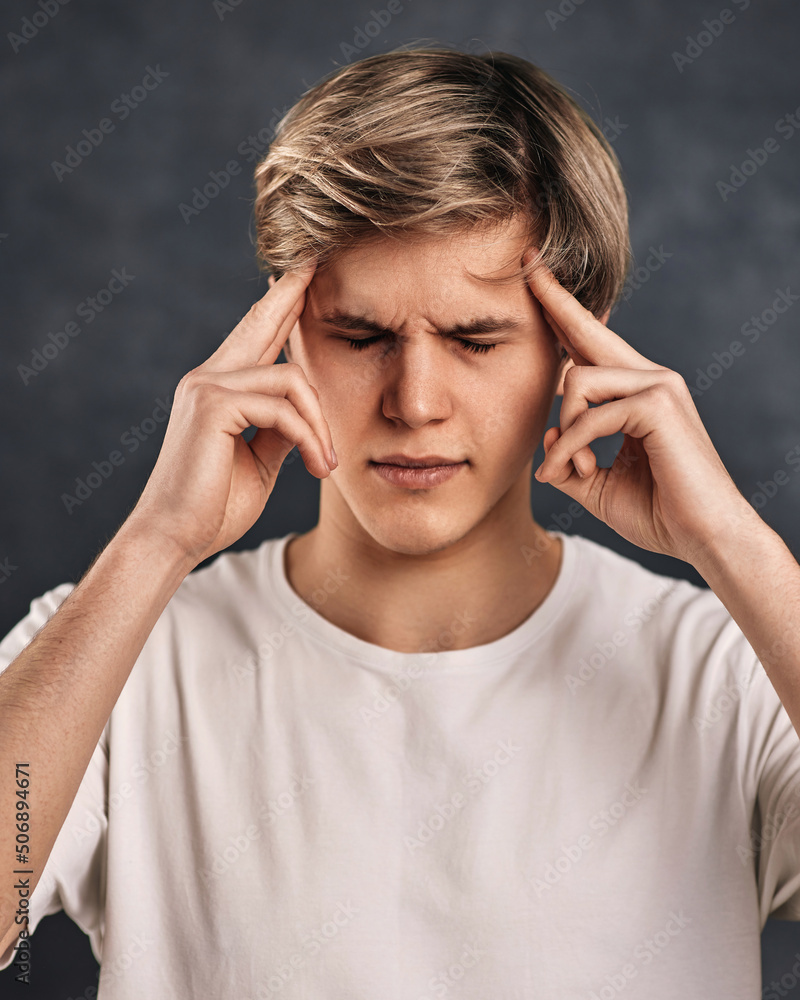 young handsome guy thinking on gray background. young handsome guy thinking on gray background.