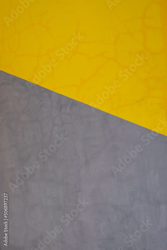 Yellow and gray geometric design painted on cement wall in Bali, Indonesia