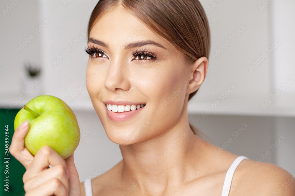 Portrait of open mouthed woman about to bite green apple Portrait of open mouthed woman about to bite green apple