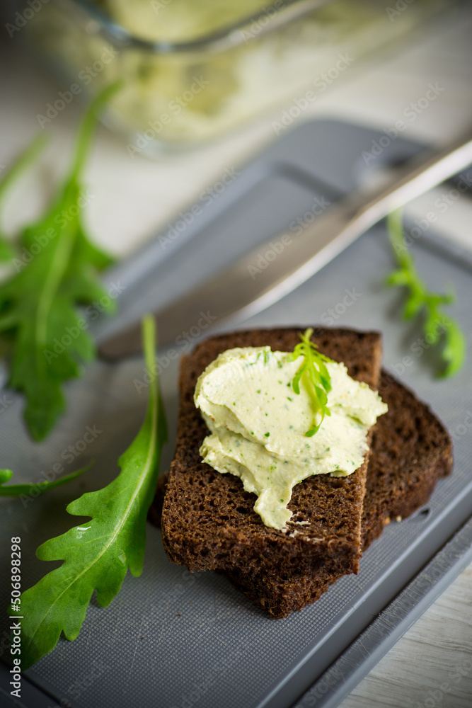 bread cheese spread with garlic and arugula on dark bread bread cheese spread with garlic and arugula on dark bread
