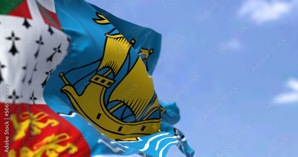 The flag of Saint Pierre and Miquelon waving in the wind on a clear day The flag of Saint Pierre and Miquelon waving in the wind on a clear day