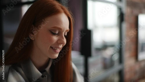 Wallpaper Mural Close-up of cheerful red-haired young woman smiling looking at laptop screen, positive emotion on face after reading good news. Pretty redhead lady chatting online. Shooting in slow motion. Torontodigital.ca