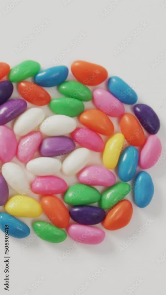 Video of overhead view of multi coloured sweets forming circle over white background Video of overhead view of multi coloured sweets forming circle over white background