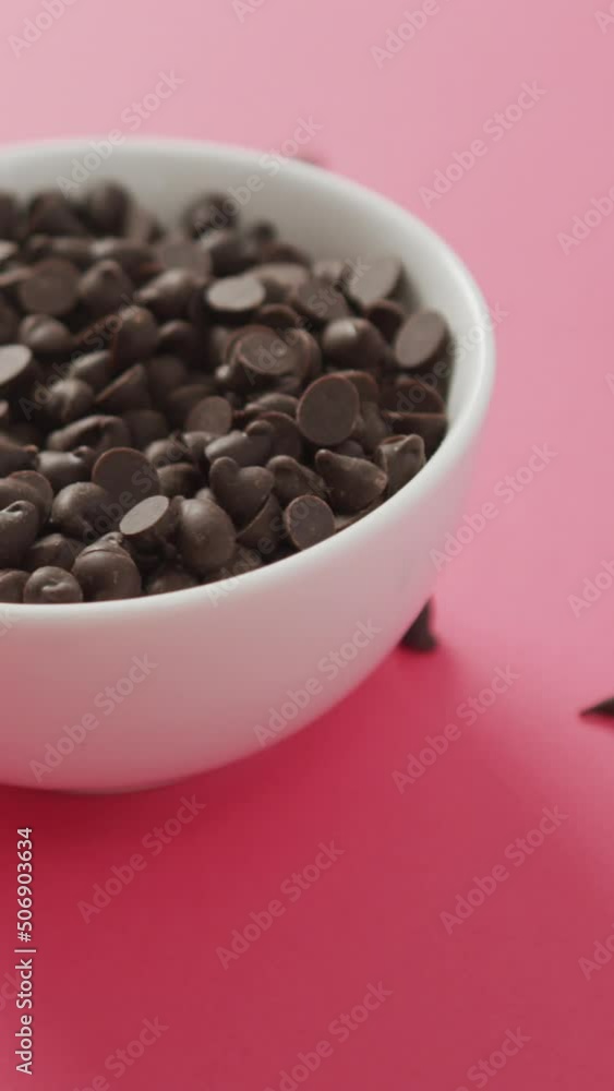 Video of bowl of chocolate chip over pink background Video of bowl of chocolate chip over pink background