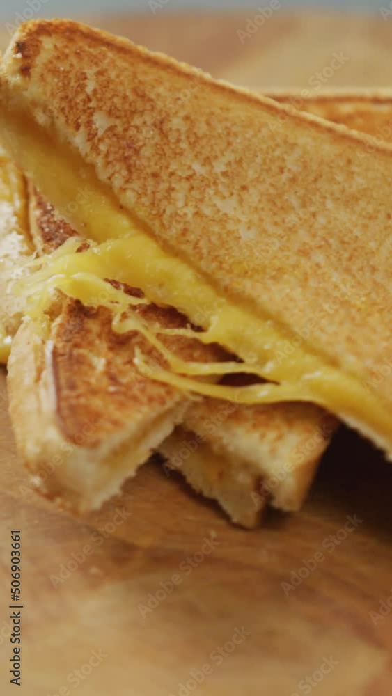 Video of close up of freshly prepared cheese white bread sandwich on wooden board Video of close up of freshly prepared cheese white bread sandwich on wooden board