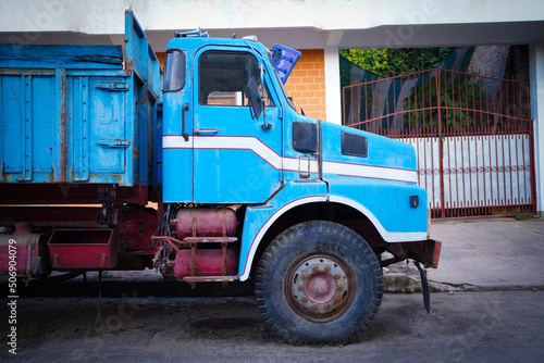 Old blue truck parking on the street.