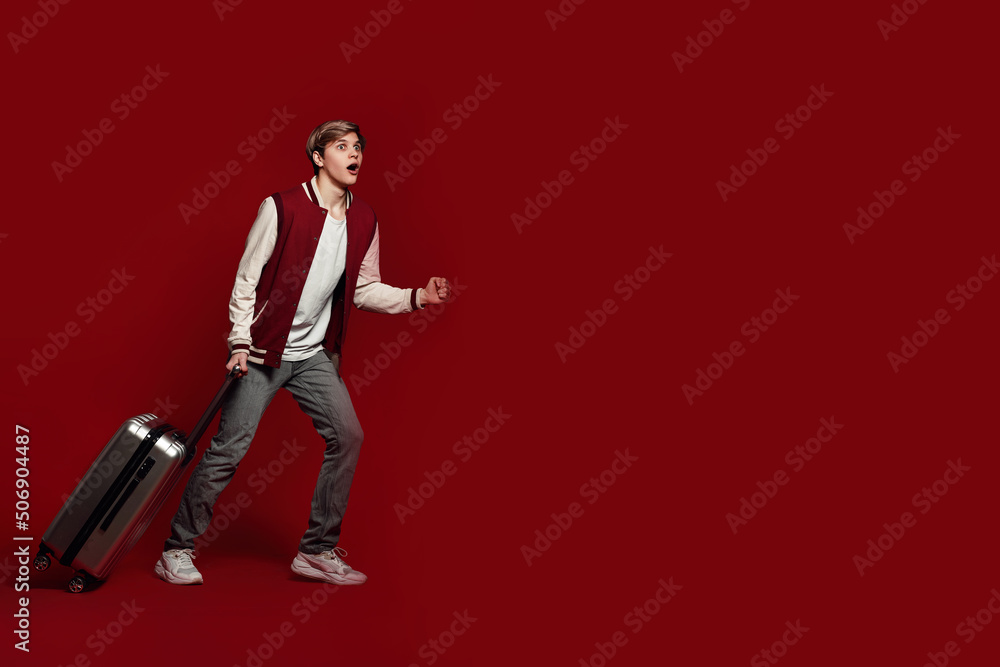 Young excited caucasian man tourist with suitcase Young excited caucasian man tourist with suitcase