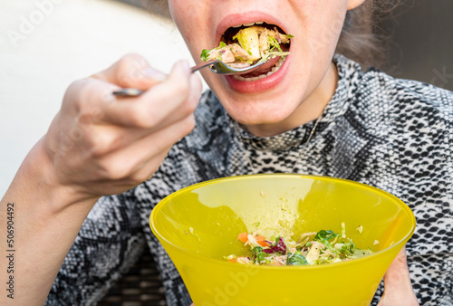 Woman eating a fresh vegan salad