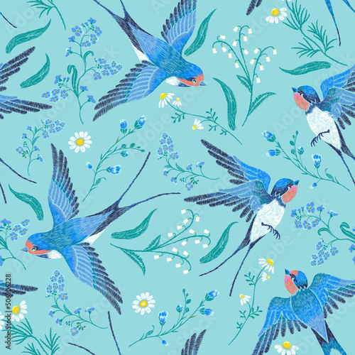 Embroidery seamless pattern with blue forget-me-not flowers, chamomile, lily of the valley and  swallows on a blue background